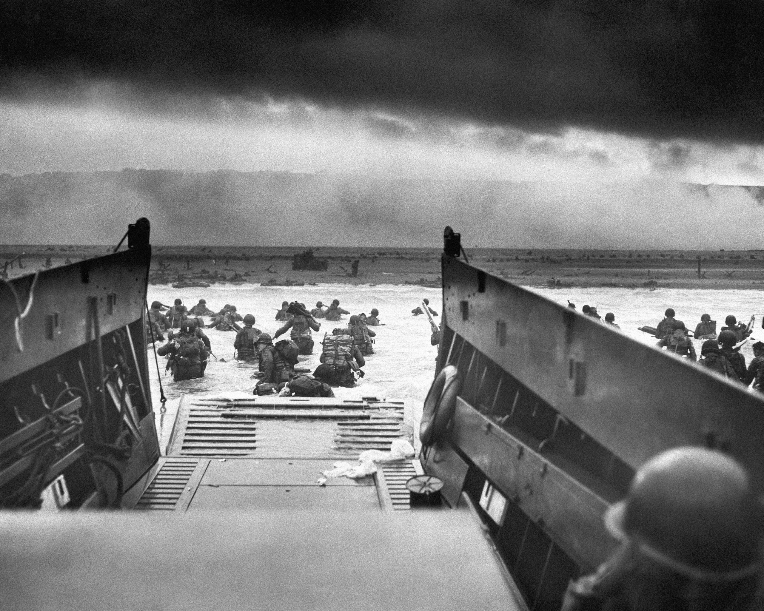 This photograph is believed to show E Company, 16th Regiment, 1st Infantry Division, participating in the first wave of assaults during D-Day in Normandy, France, June 6, 1944. The greatest armada ever assembled, nearly 7,000 ships and boats, supported by more than 11,000 planes, carried almost 133,000 troops across the Channel to establish toeholds on five heavily defended beaches stretched across 80 kilometers (50 miles) of Normandy coast. More than 9,000 Allied soldiers were killed or wounded in the first 24 hours. (Chief Photographer's Mate Robert M. Sargent, U.S. Coast Guard via AP, File)