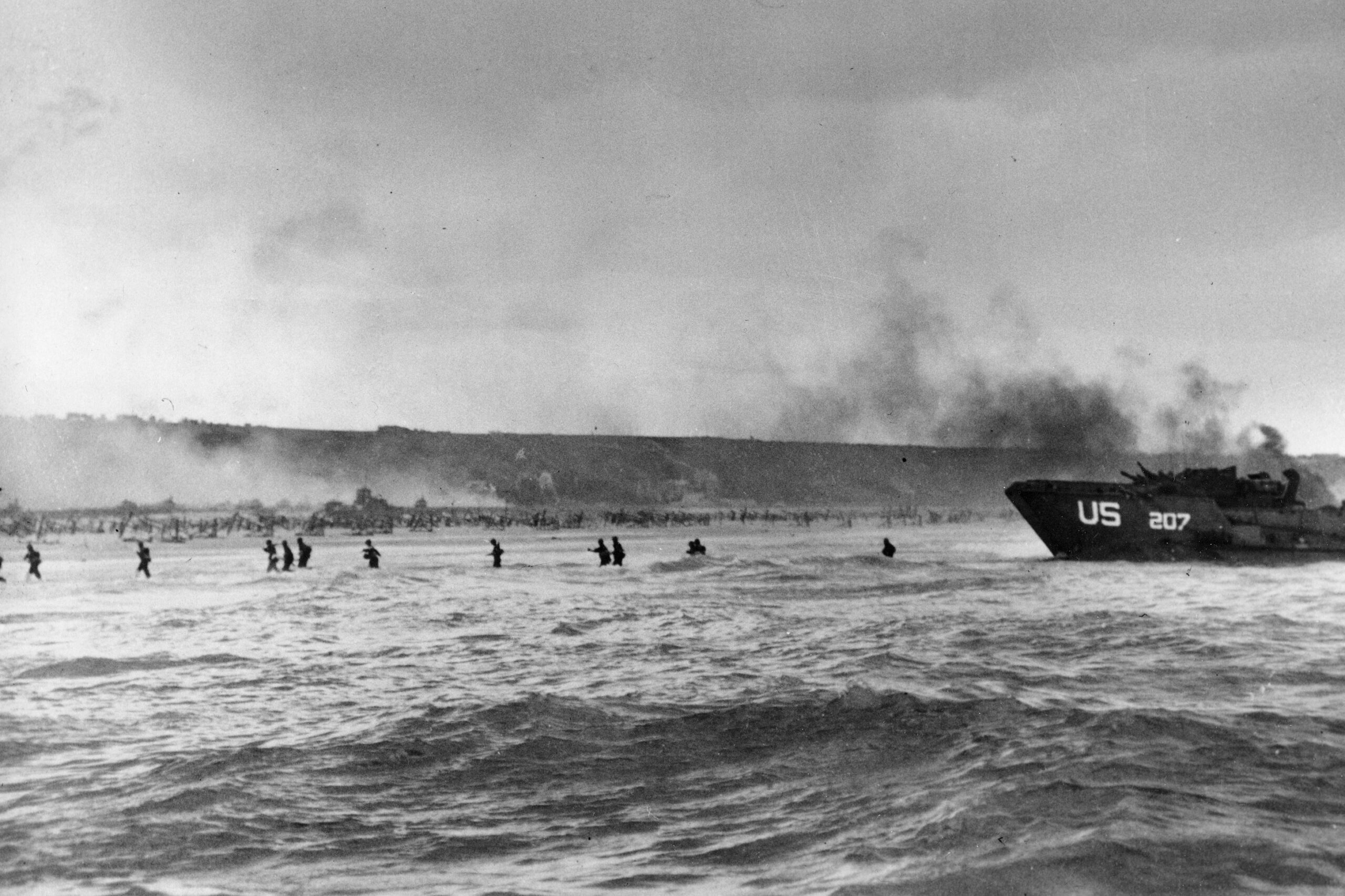 Under the cover of naval shell fire, American infantrymen wade ashore from their landing craft during the initial Normandy landing operations in France, June 6, 1944. More than 2,200 Allied aircraft begin bombing German defenses and other targets in Normandy. They are followed by 1,200 aircraft carrying more than 23,000 American, British and Canadian airborne troops. British forces landing in gliders take two strategic bridges near the city of Caen. (AP Photo/Peter Carroll, File)