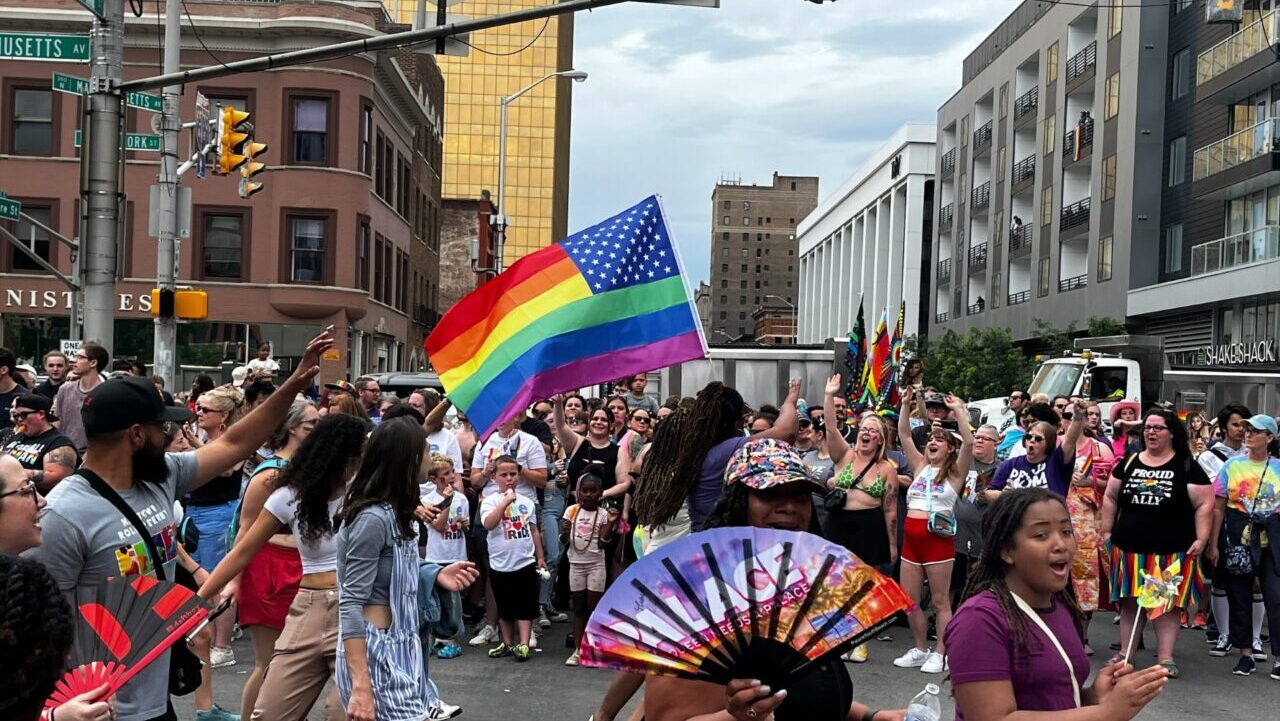 People march and wave flags in the 2024 Indy Pride Parade.