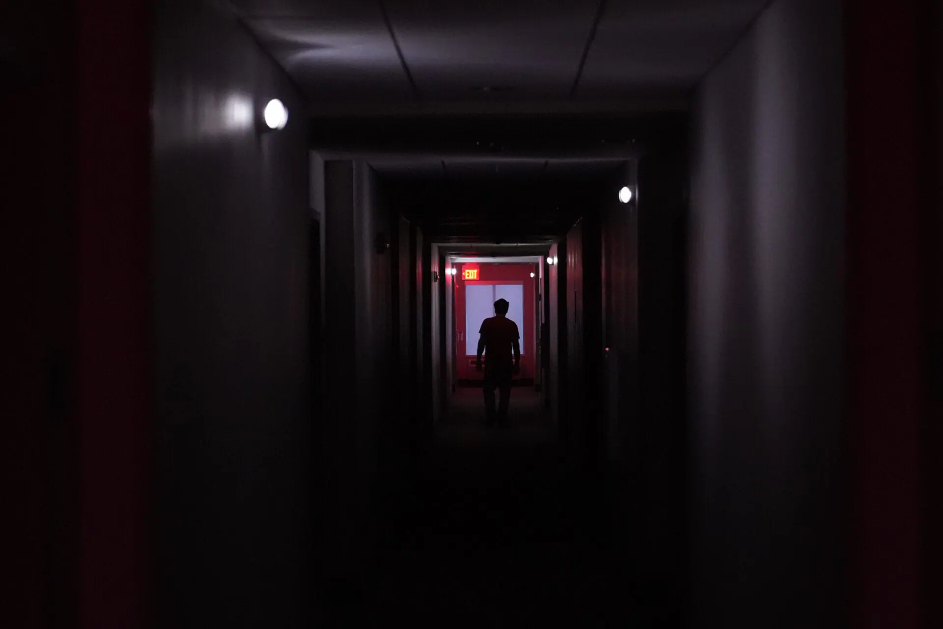 A hotel guest navigates the halls after power was lost due to Hurricane Beryl, Monday, July 8, 2024, in Bay City, Texas. (AP Photo/Eric Gay)