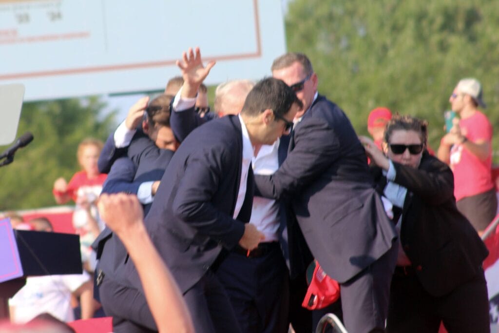 Former President Donald Trump being escorted away by Secret Service agents after being shot during a rally in Butler, Pennsylvania, on July 13, 2024. (Provided Photo/Josh Drespling)