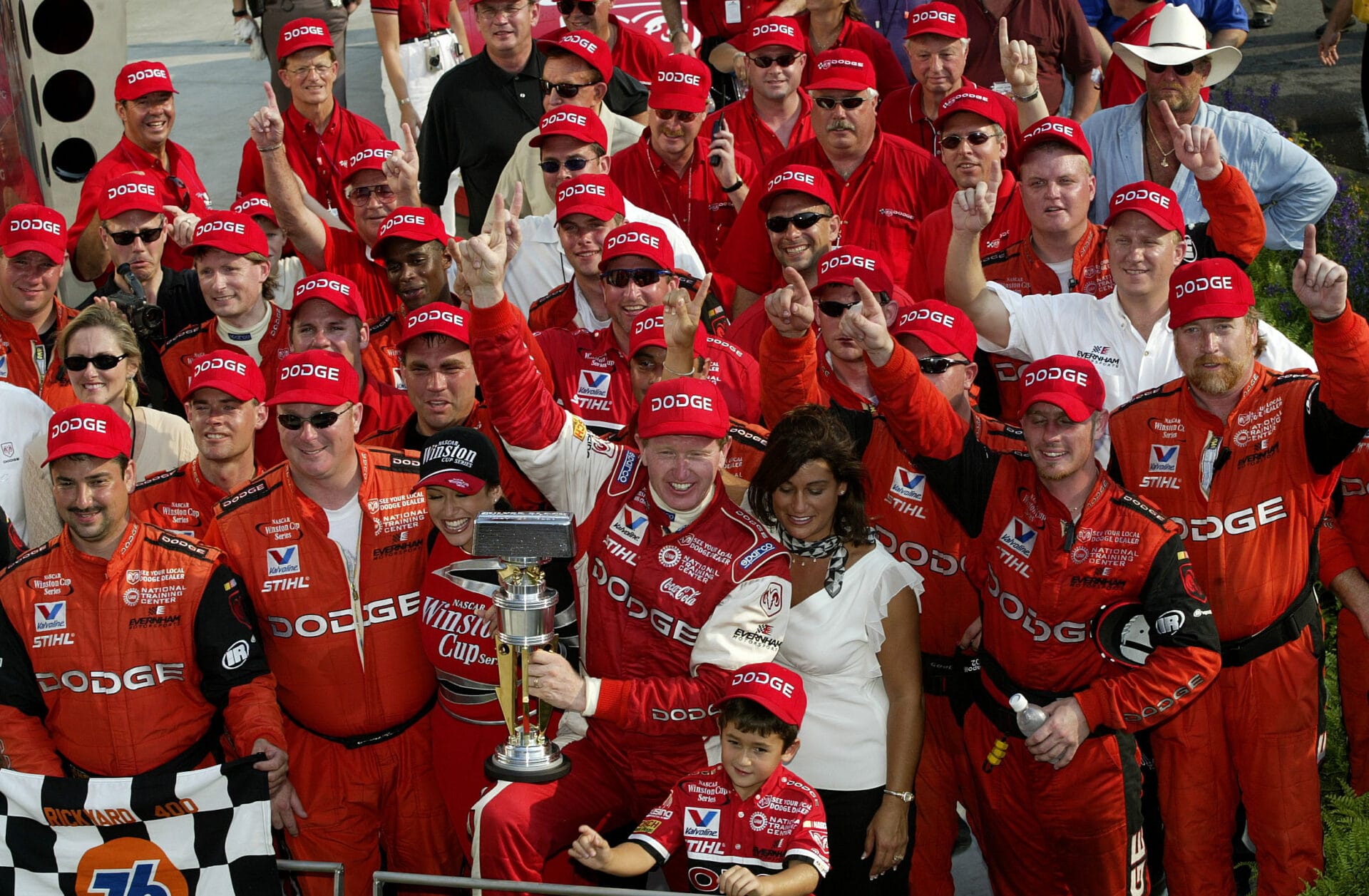 Bill Elliott celebrates with is #9 Evernham Motorsports Dodge teammates on August 4, 2002 after winning the Brickyard 400 at Indianapolis Motor Speedway. His son, pictured front row center, would go on to win the 2020 Cup Series championship.(Photo by Jonathan Ferrey/Getty Images)