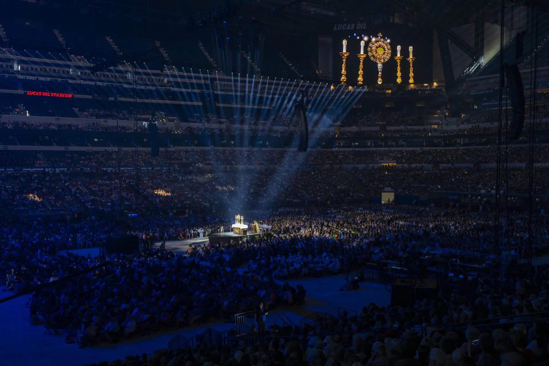 Bishop Andrew Cozzens prays before a monstrance during the Eucharistic Adoration of the National Eucharistic Congress opening ceremonies, July 17, 2024, at Lucas Oil Stadium in Indianapolis. (AP Photo/Doug McSchooler)