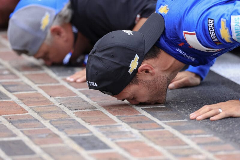 Kyle Larson, driver of the #5 HendrickCars.com Chevrolet, kisses the yard of bricks after winning the NASCAR Cup Series Brickyard 400 at Indianapolis Motor Speedway on July 21, 2024 in Indianapolis, Indiana. (Photo by Justin Casterline/Getty Images)