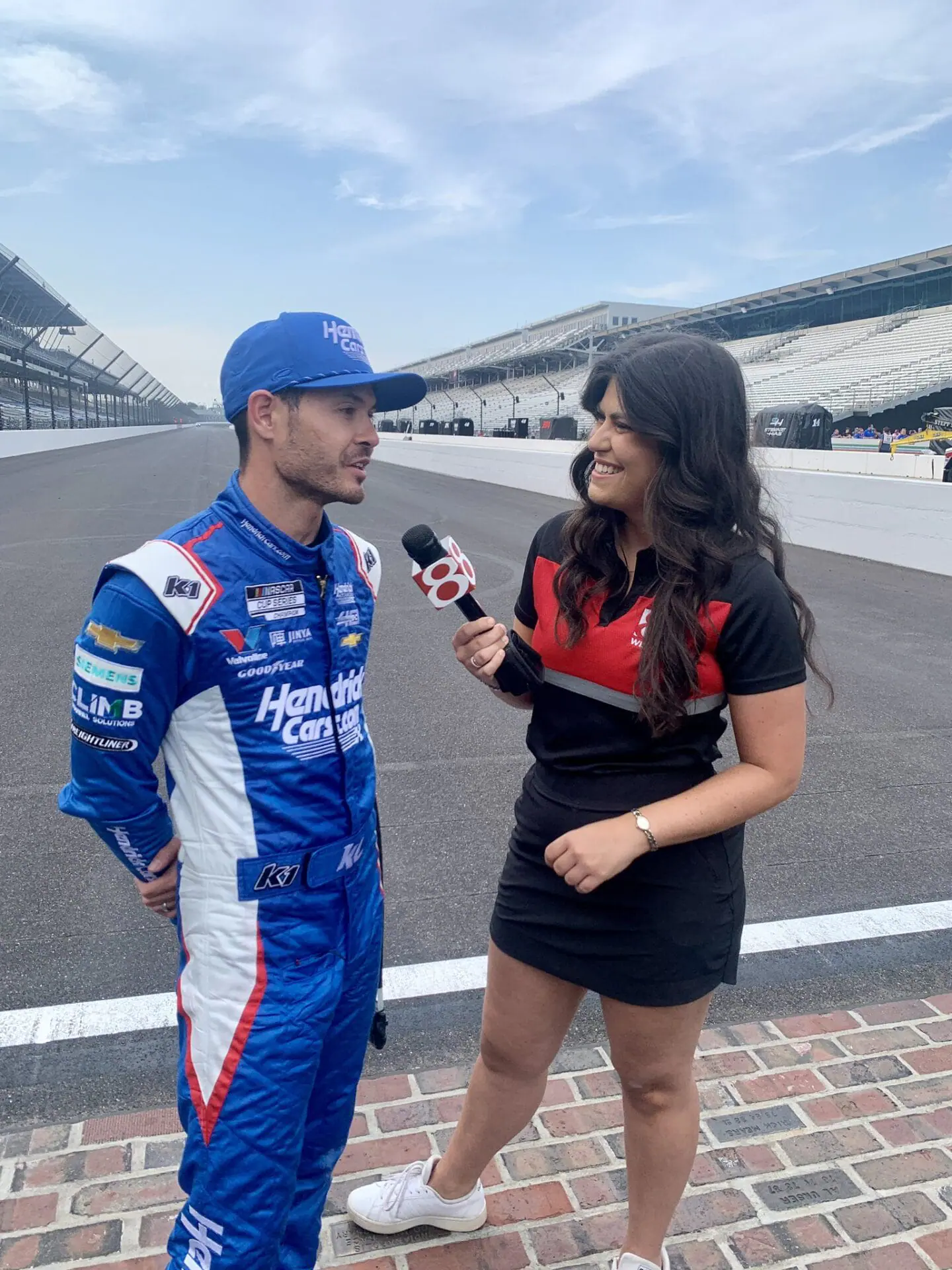 News 8 sports reporter Angela Moryan interviews 2024 Brickyard 400 Kyle Larson winner on the famed Yard of Bricks at Indianapolis Motor Speedway on July 21, 2024. (WISH Photo/Angela Moryan via X)