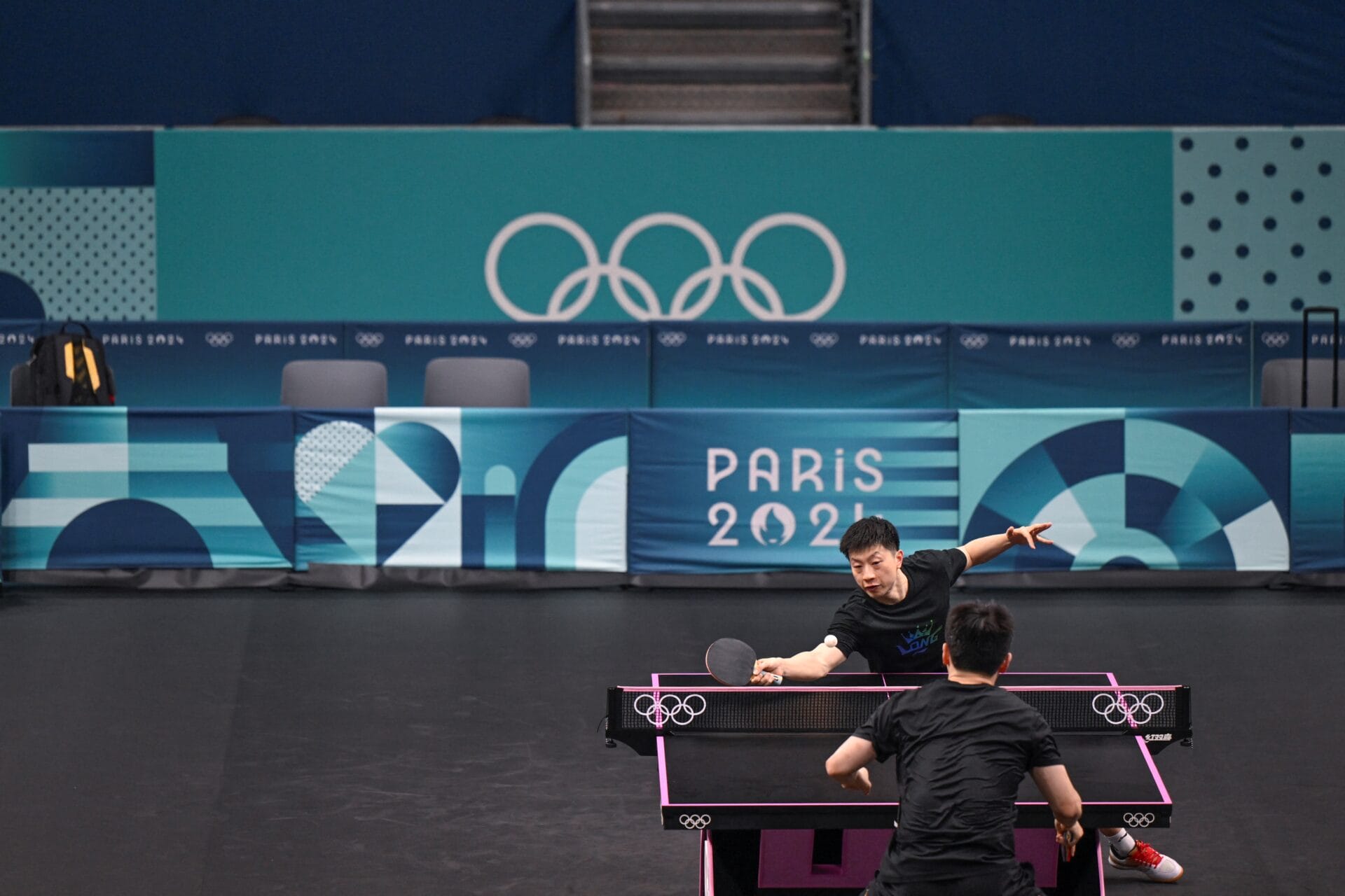 China's table tennis player Ma Long (back) practices during a training session at South Arena in Paris on July 23, 2024, ahead of the Paris 2024 Olympic Games. (Photo by WANG Zhao / AFP) (Photo by WANG ZHAO/AFP via Getty Images)