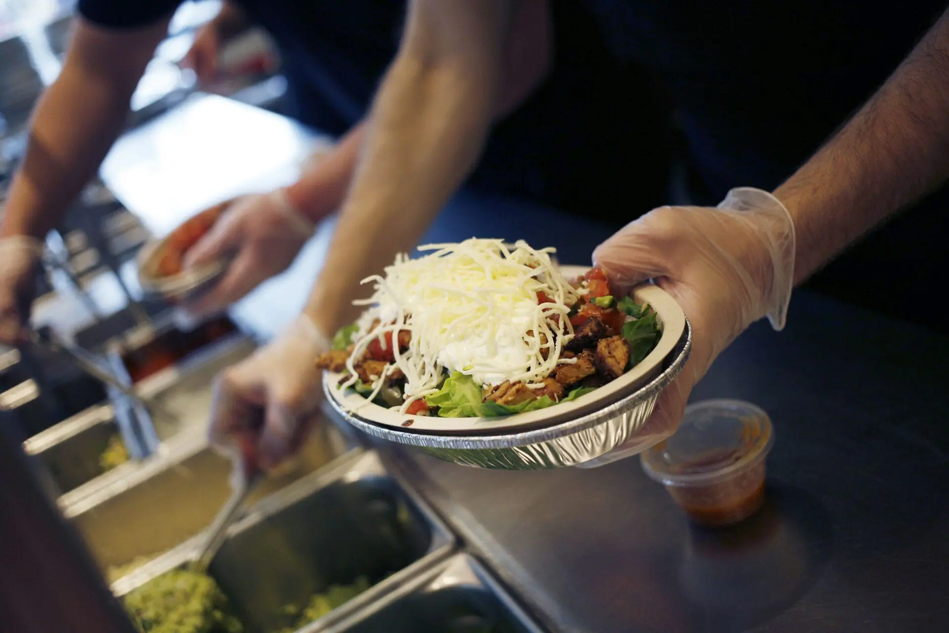 An employee prepares a burrito bowl at a Chipotle Mexican Grill Inc. restaurant in Louisville, Kentucky, in February 2019. (Photo by Luke Sharrett/Bloomberg/Getty Images/File via CNN Newsource)