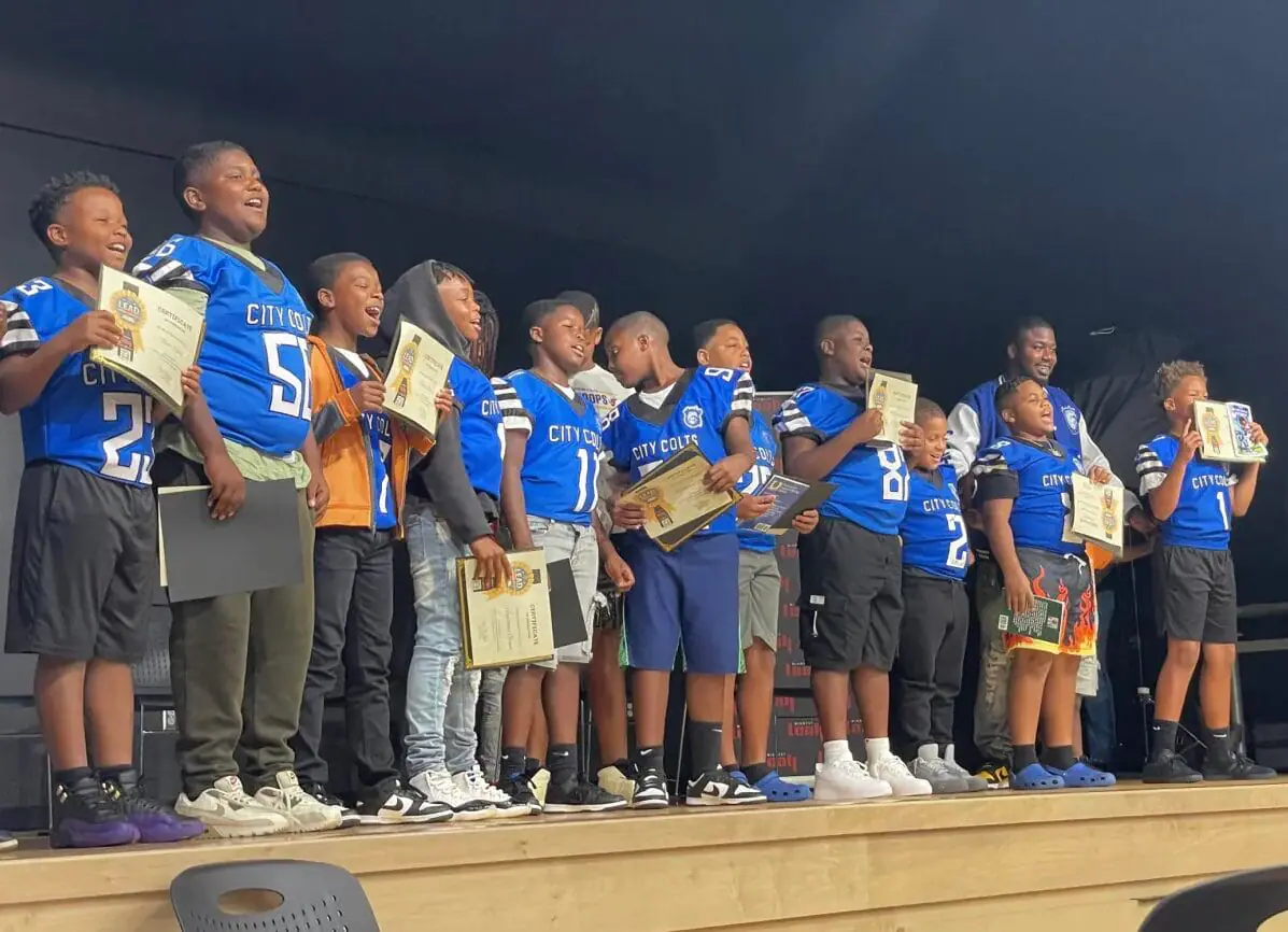 Kids from City Colts receive their published books at the Literacy Entrepreneurship and Dreams program graduation at Frederick Douglass Park Aug. 1. (Provided Photo/Darian Benson/Mirror Indy)