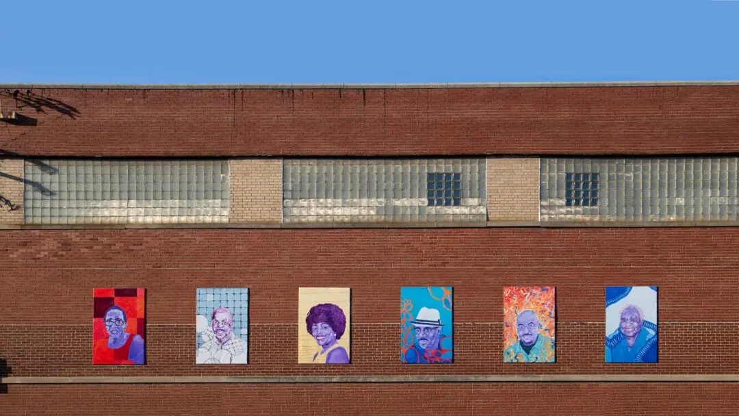 Portraits of Greatriarchs hang a long building in Martindale-Brightwood Neighborhood. (Photo provided by/ The Harrison Center)