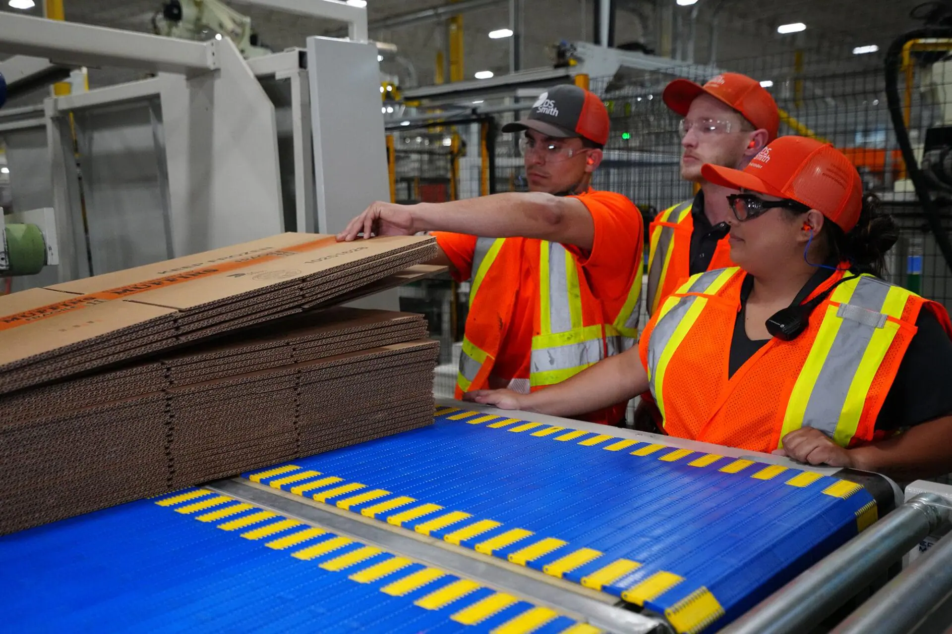 Interpreter Elissa Ramirez, right, helps supervisor Stacey Thomas, center, train machine operator Eduardo Vera at DS Smith's packaging facility in Lebanon, Indiana. (Provided Photo/Becky Gordon/DS Smith via CNN Newsource)