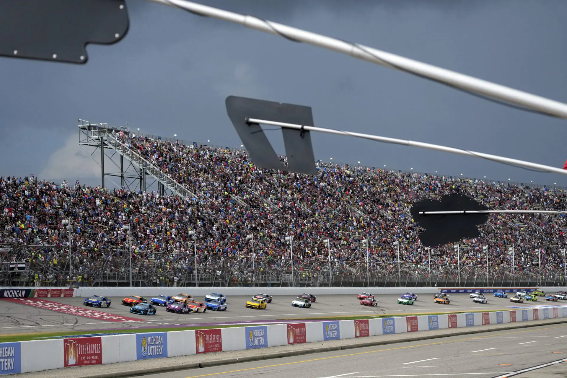 With rain clouds approaching, drivers compete during a NASCAR Cup Series auto race at Michigan International Speedway, Sunday, Aug. 18, 2024, in Brooklyn, Mich. (AP Photo/Carlos Osorio)