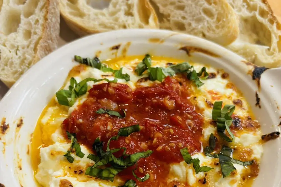 A baked ricotta dip, a house specialty at the recently opened Rosemary & Olive Restaurant on Mass Ave. in Indianapolis. (Provided Photo/Rosemary & Olive Restaurant via Facebook)