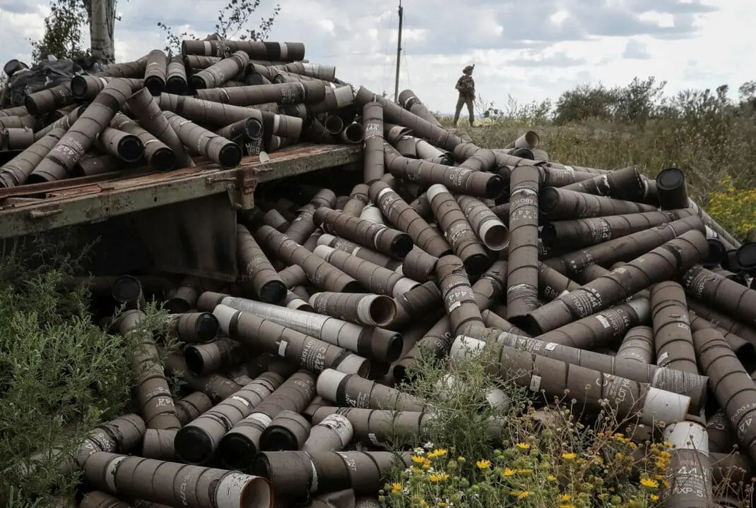 A Ukrainian soldier stands near used shell cartridges as he patrols an area in Ukraine's Donetsk region. (Photo by Oleksandr Klymenko/Reuters via CNN Newsource)