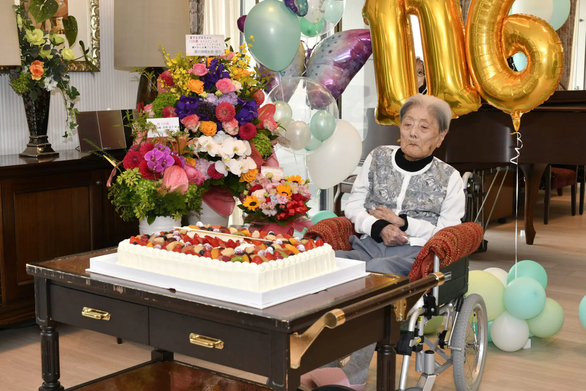 This photo provided by the city of Ashiya shows Tomiko Itooka, being celebrated for her 116th birthday at the nursing home she lives in Ashiya, western Japan, on May 23, 2024. (City of Ashiya via AP)