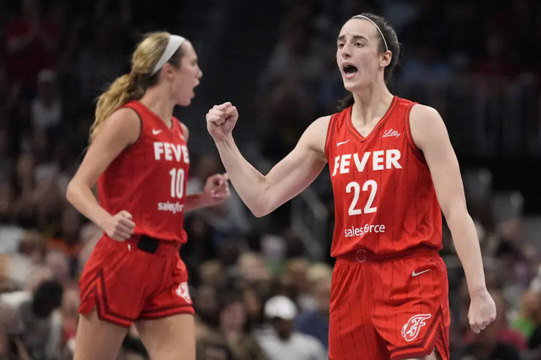 Indiana Fever guard Caitlin Clark (22) reacts after the team scores in the second half of an WNBA basketball game against the Atlanta Dream, Monday, Aug. 26, 2024, in Atlanta. (AP Photo/Brynn Anderson)