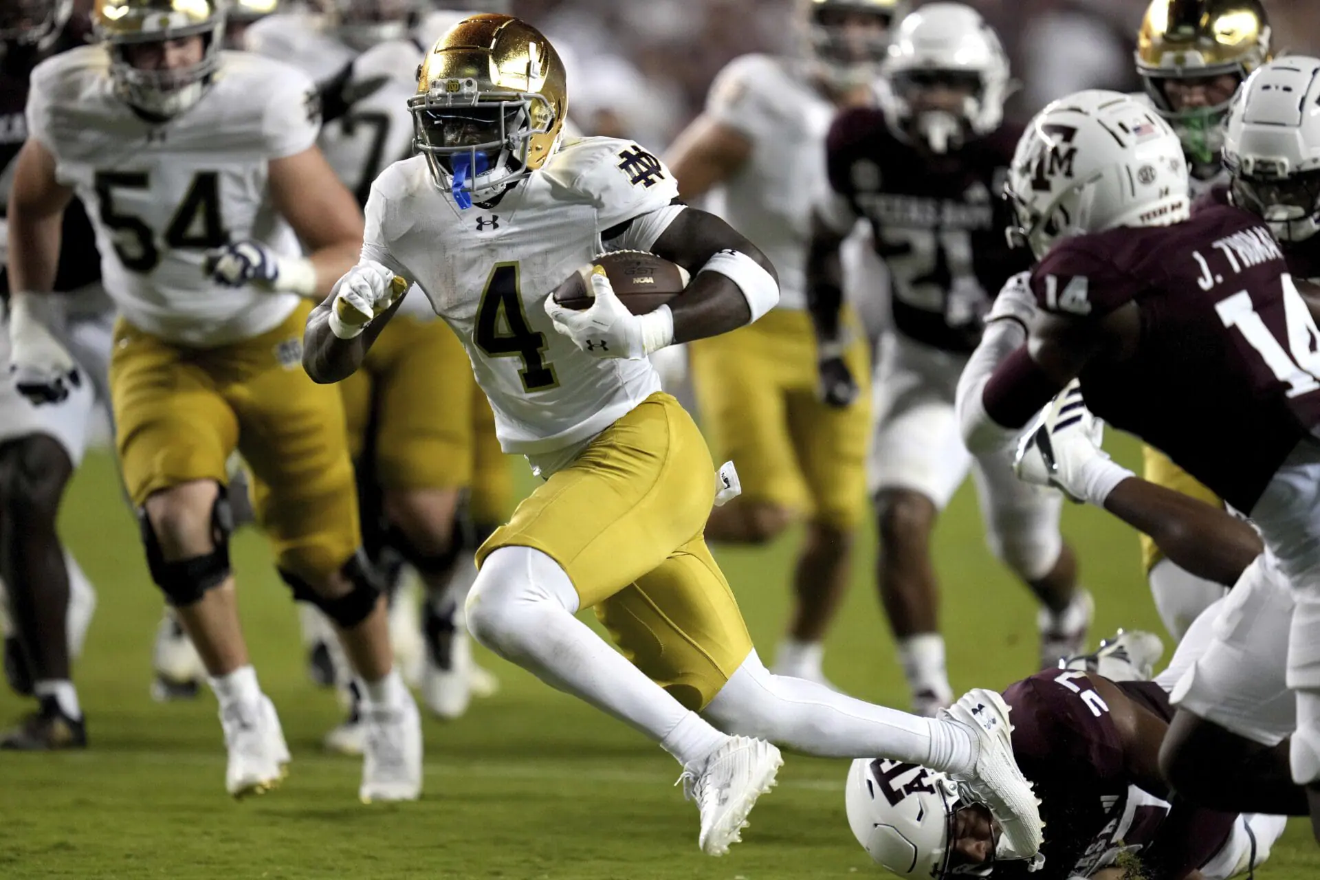 Notre Dame running back Jeremiyah Love (4) breaks free from Texas A&M linebacker Daymion Sanford (27) for a touchdown run late in the fourth quarter of an NCAA college football game Saturday, Aug. 31, 2024, in College Station, Texas. (AP Photo/Sam Craft)