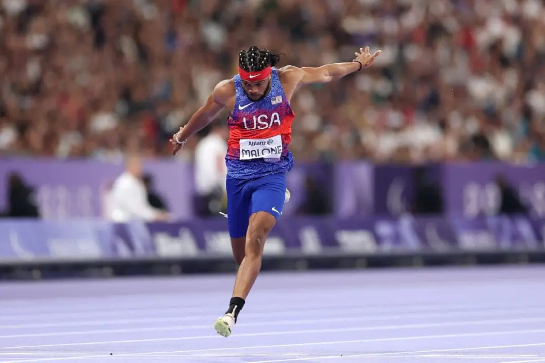 Noah Malone of Team United States crosses the finish line in the Para Athletics Men's 100m - T12 Final on day three of the Paris 2024 Summer Paralympic Games at Stade de France on August 31, 2024 in Paris, France. (Photo by Fiona Goodall/Getty Images for PNZ)