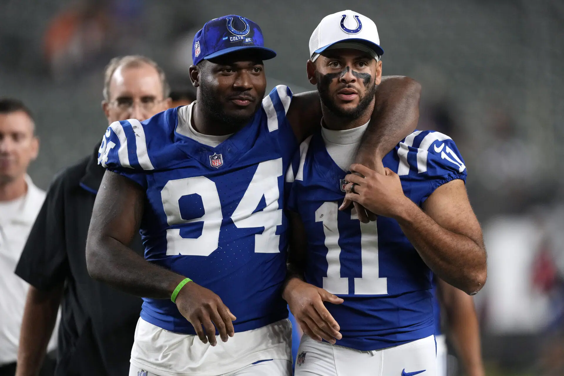 Indianapolis Colts defensive end Tyquan Lewis (94) walks off the field with teammate wide receiver Michael Pittman Jr. (11) after a preseason NFL football game against the Cincinnati Bengals, Thursday, Aug. 22, 2024, in Cincinnati. The Colts won 27-14. (AP Photo/Carolyn Kaster)