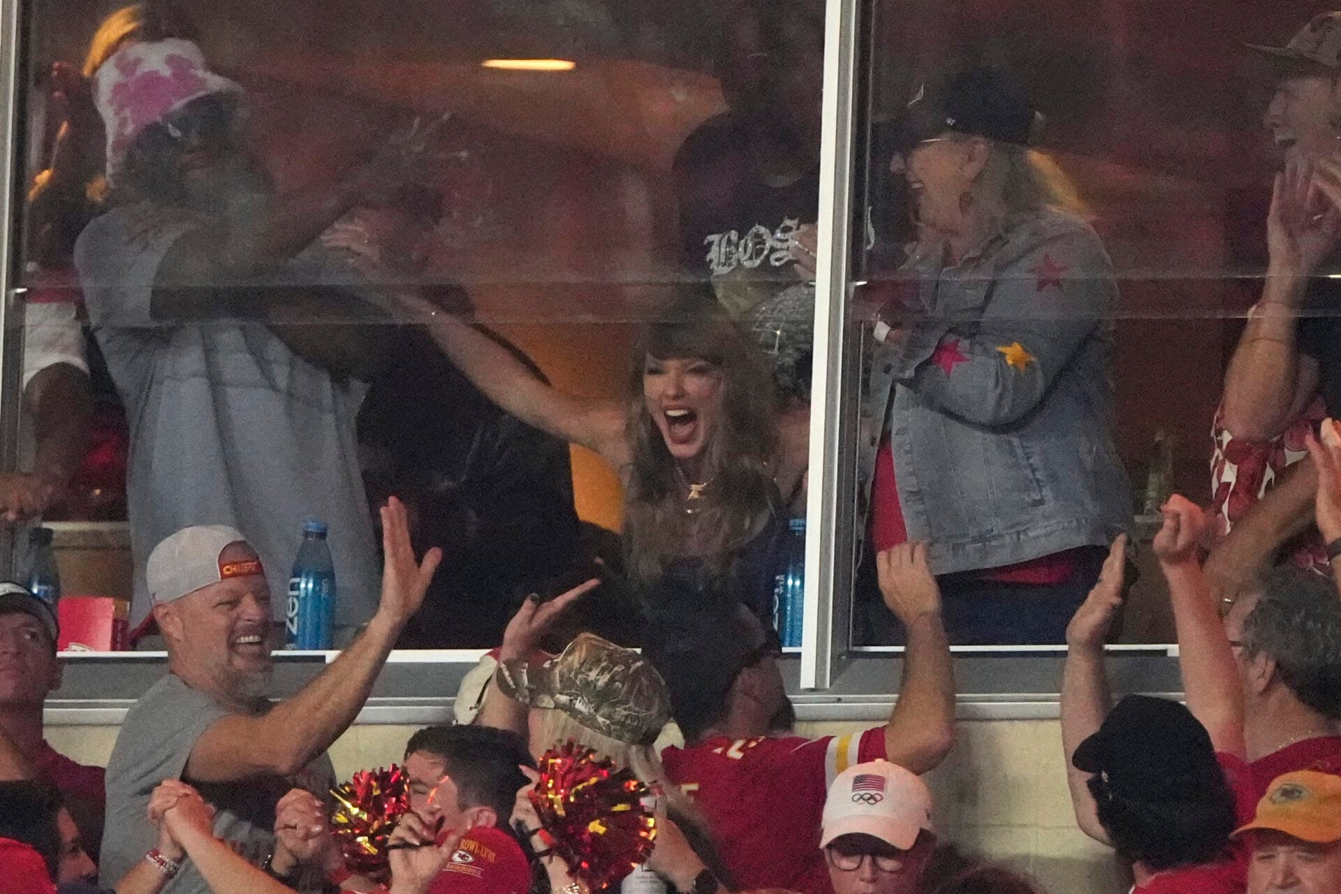 Taylor Swift cheers in a suite during the first half of an NFL football game between the Kansas City Chiefs and the Baltimore Ravens Thursday, Sept. 5, 2024, in Kansas City, Mo. (AP Photo/Charlie Riedel)