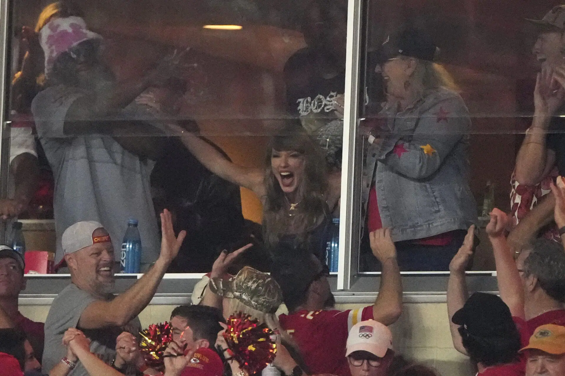 Taylor Swift cheers in a suite during the first half of an NFL football game between the Kansas City Chiefs and the Baltimore Ravens Thursday, Sept. 5, 2024, in Kansas City, Mo. (AP Photo/Charlie Riedel)