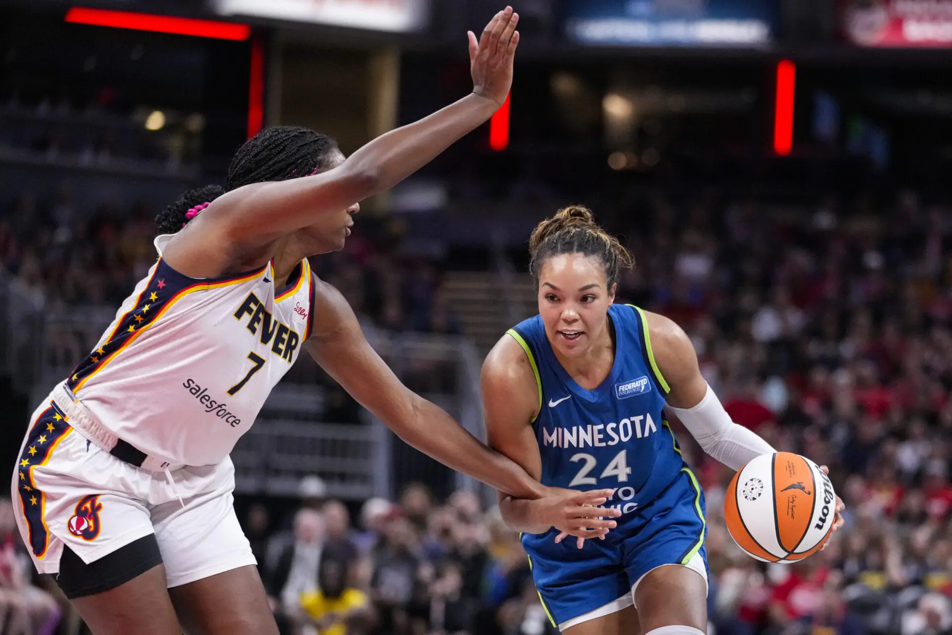 Minnesota Lynx forward Napheesa Collier (24) drives on Indiana Fever forward Aliyah Boston (7) in the first half of a WNBA basketball game in Indianapolis, Friday, Sept. 6, 2024. (AP Photo/Michael Conroy)