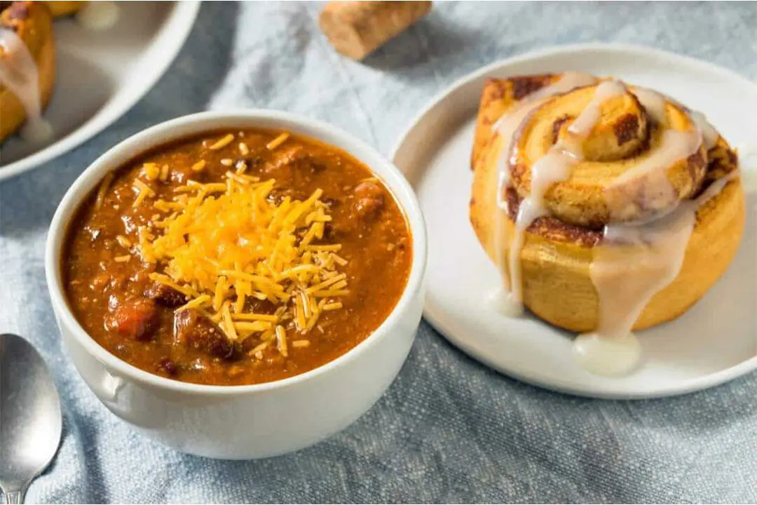 A bowl of chili topped with cheese and a cinnamon roll. Try fall's most unconventional food combos. These bold pairings might just be your new favorites - or not! (Photo by Depositphotos via AP)