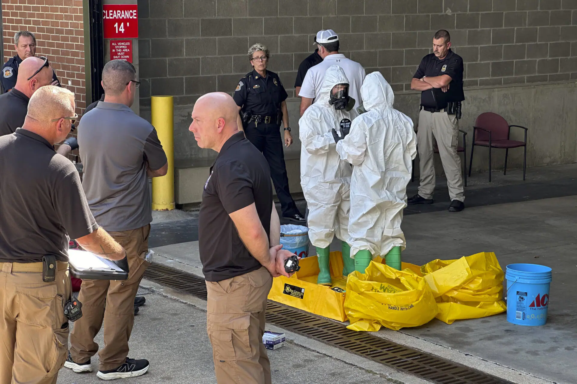 A hazmat crew from the National Guard's Civilian Support Team investigates after a suspicious package was delivered to election officials at the Missouri Secretary of State's Jefferson City, Mo., office on Tuesday Sept. 17, 2024. (AP Photo/Summer Ballentine)