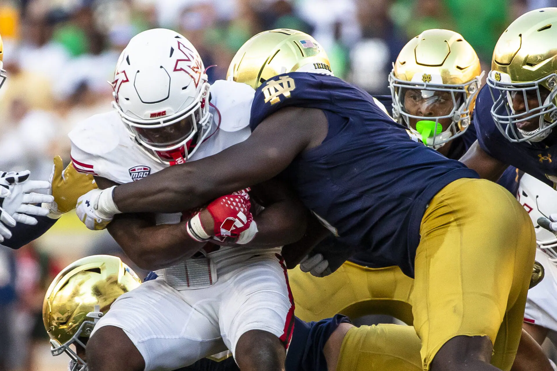 Notre Dame defensive lineman RJ Oben, right, wraps up Miami (Ohio) running back Jordan Brunson, left, during the second half of an NCAA college football game Saturday, Sept. 21, 2024, in South Bend, Ind. (AP Photo/Michael Caterina)