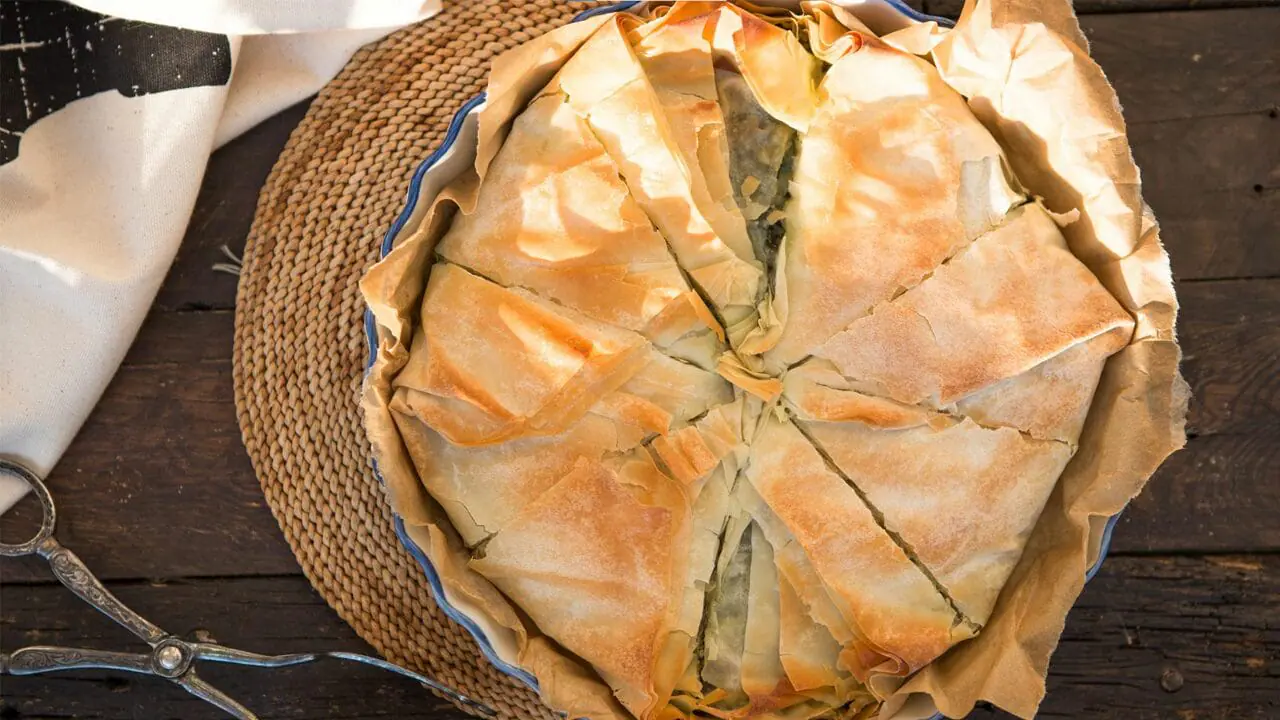 spanikopita (spinach pie) sliced in a pie pan