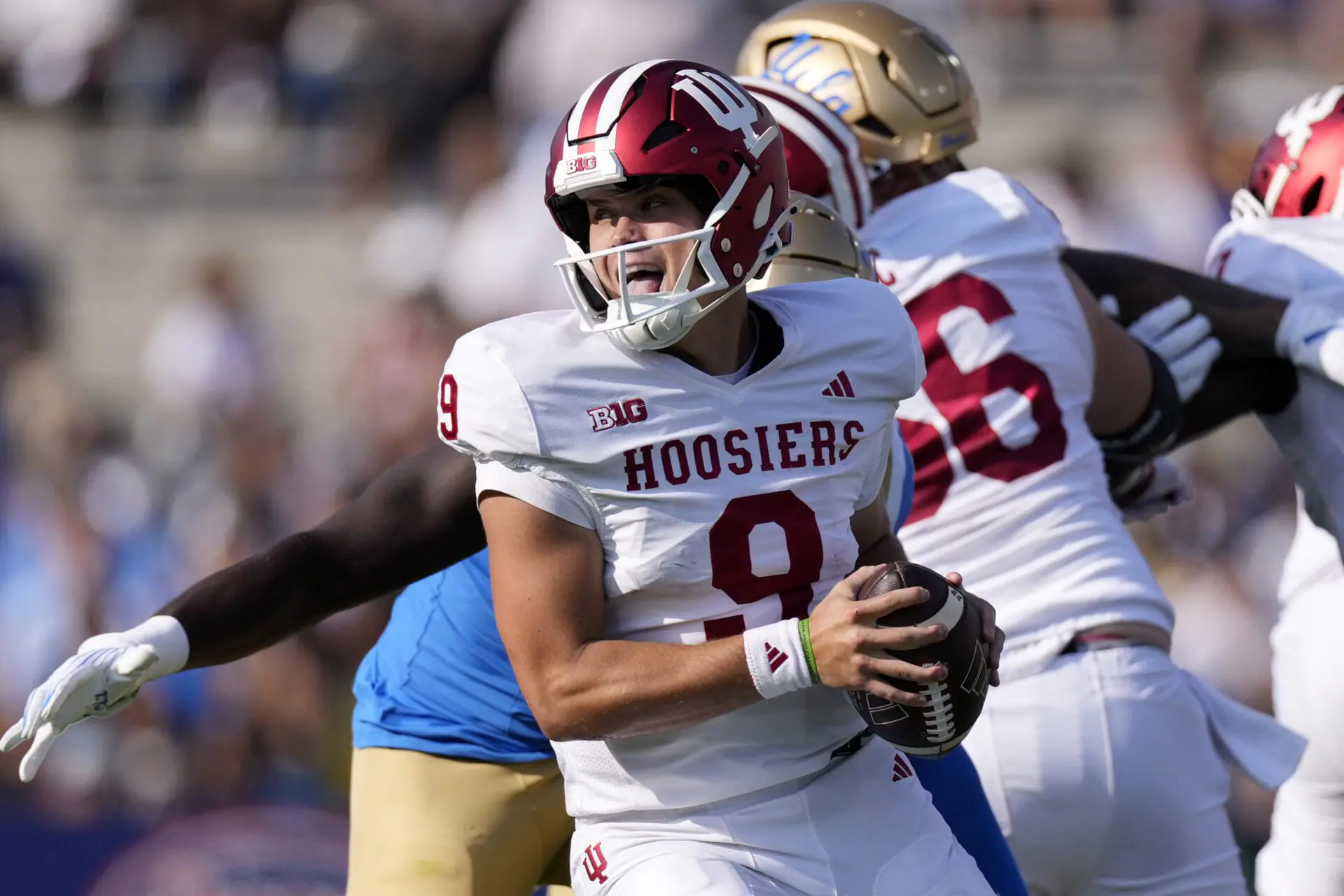 Indiana quarterback Kurtis Rourke avoids a tackles as he rolls out during the first half of an NCAA college football game against UCLA, Saturday, Sept. 14, 2024, in Pasadena, Calif. (AP Photo/Mark J. Terrill)