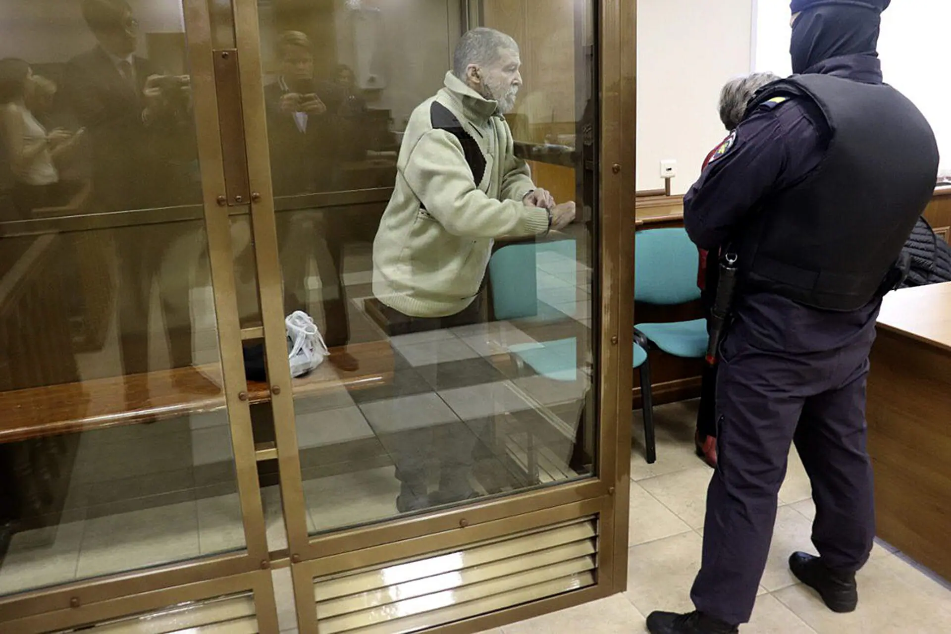 In this photo released by the Moscow City Court Press Service, Stephen Hubbard, a U.S. citizen accused of fighting as a mercenary in Ukraine against Russia stands in a glass cage during a court session in the Moscow City court in Moscow, Russia, Monday, Oct. 7, 2024. (Moscow City Court Press Service via AP)