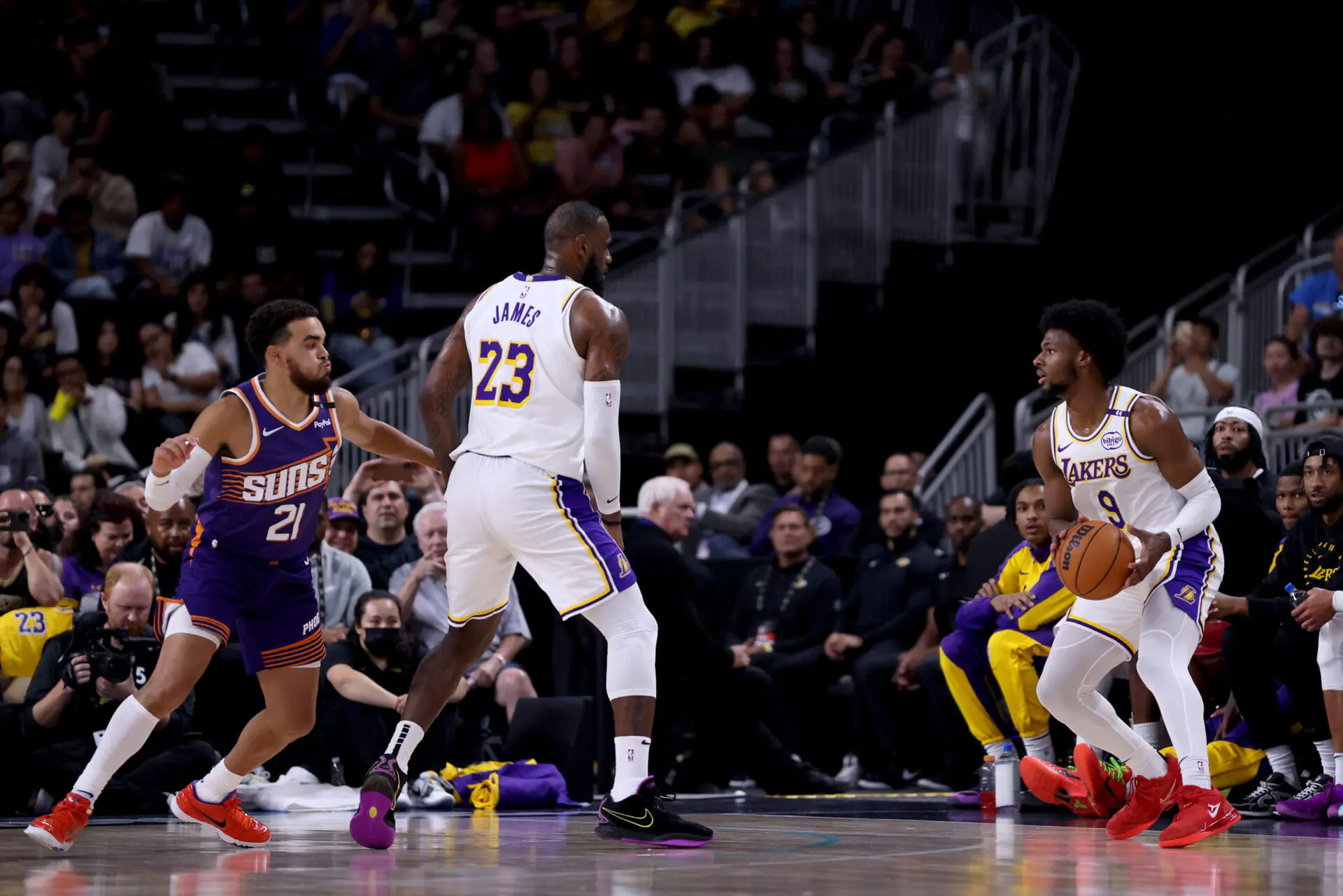 PALM SPRINGS, CALIFORNIA - OCTOBER 06: LeBron James #23 of the Los Angeles Lakers sets a screen for Bronny James #9 against Tyus Jones #21 of the Phoenix Suns during the second quarter at Acrisure Arena on October 06, 2024 in Palm Springs, California. (Photo by Katelyn Mulcahy/Getty Images)