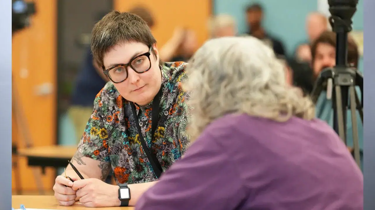 Mirror Indy data reporter Emily Hopkins listens to a community member at a public meeting. Contrary to what you may have seen on the Indianapolis Public Schools website, you will be voting for a candidate to represent IPS board District 2. Until Oct. 2, the IPS website had the area — technically Precinct CN049 — situated in District 1. (Photo by Jenna Watson/Mirror Indy)