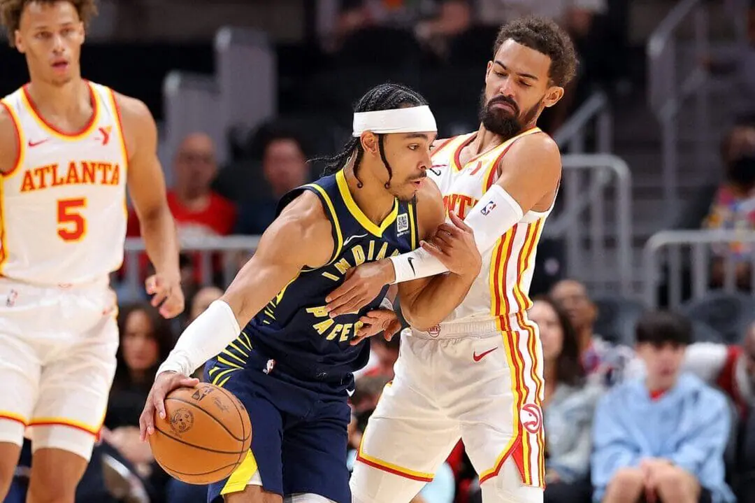 Andrew Nembhard #2 of the Indiana Pacers drives against Trae Young #11 of the Atlanta Hawks during the first quarter at State Farm Arena on October 08, 2024 in Atlanta, Georgia. NOTE TO USER: User expressly acknowledges and agrees that, by downloading and/or using this photograph, user is consenting to the terms and conditions of the Getty Images License Agreement. (Photo by Kevin C. Cox/Getty Images)