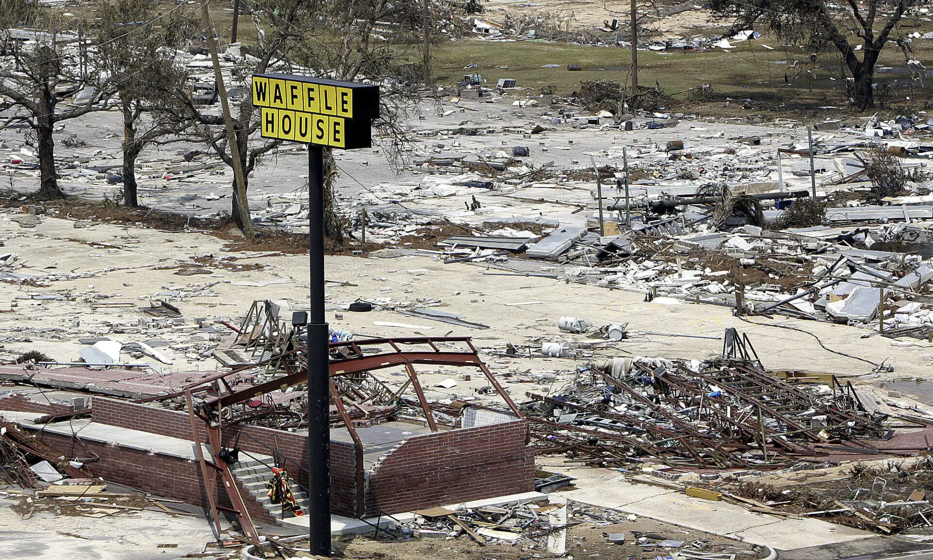 A sign is all that's left of this Waffle House on the beach in Gulfport, Miss., Aug. 31, 2005. (AP Photo/Phil Coale, File)