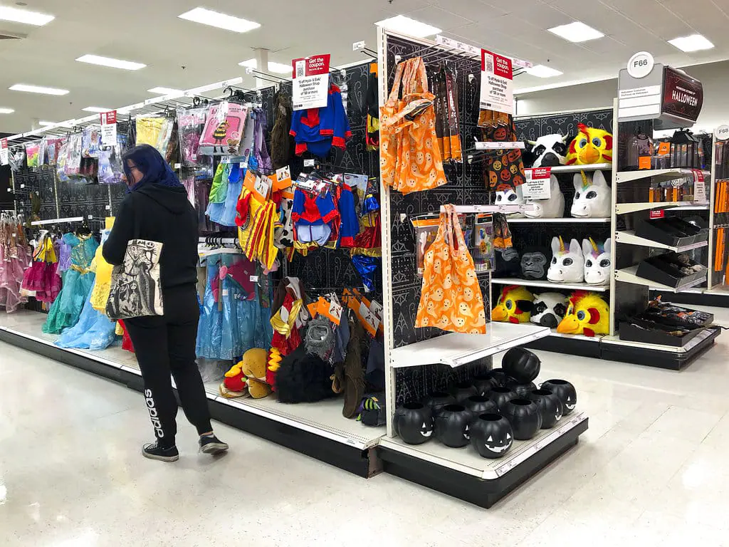 A customer looks through kids Halloween costumes at a Target department store on Tuesday, Oct. 2, 2018, in Aventura, Fla. (AP Photo/Brynn Anderson)