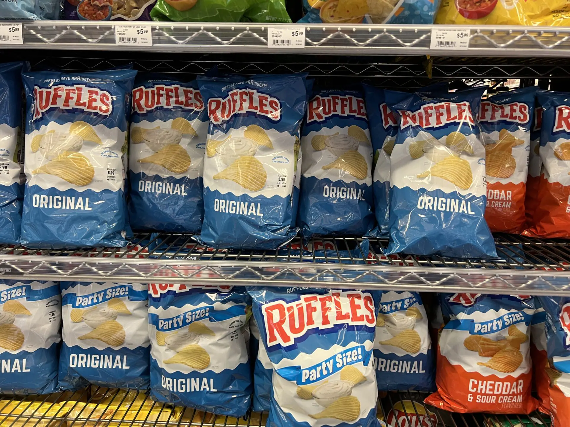 Display with bags of Ruffles potato chips at a supermarket in Lafayette, California, June 17, 2024. PepsiCo is reversing the trend of shrinkflation with larger bags of Tostitos and Ruffles, offering 20% more chips for the same price. (Photo by Smith Collection/Gado/Getty Images)