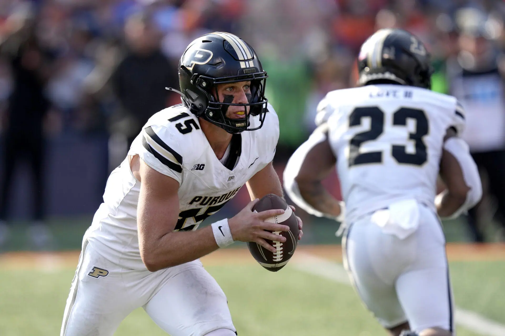 Purdue quarterback Ryan Browne carries the ball during the first half of an NCAA college football game against Illinois on Saturday, Oct. 12, 2024, in Champaign, Ill. (AP Photo/Charles Rex Arbogast)