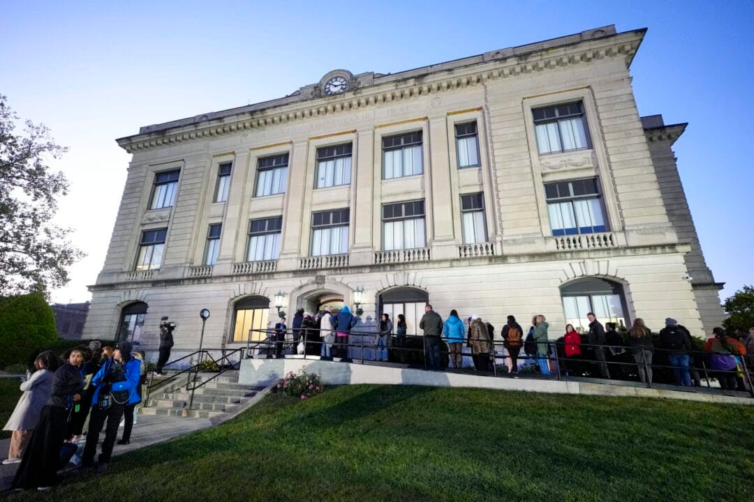 Spectators line up to enter the Carroll County Courthouse for the trail of Richard Allen, accused of the slayings of two teenage girls in 2017, started Oct. 18, 2024, and is expected to run into November, (AP Photo/Michael Conroy)