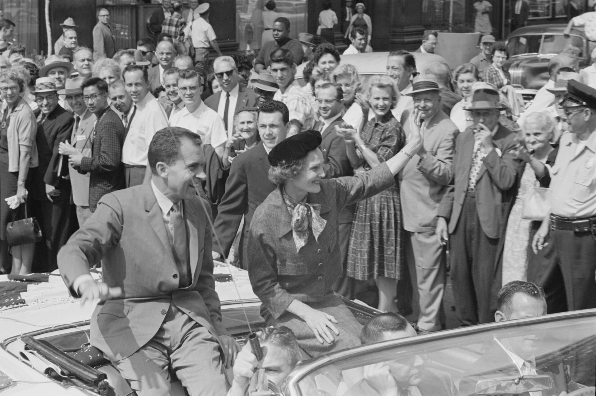 American Vice President and presidential candidate Richard Nixon and his wife Pat Nixon wave to the crowds while sitting on the back of an open top convertible while campaigning in Indianapolis, Indiana, on Sept. 14, 1960. (Photo by O'Halloran/Library of Congress/Interim Archives/Getty Images)