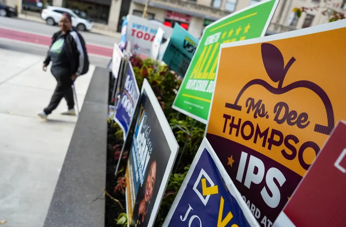 People pass by campaign signs on Election Day, Nov. 5, 2024, at the City-County Building in Indianapolis. (Provided Photo/Jenna Watson/Mirror Indy)