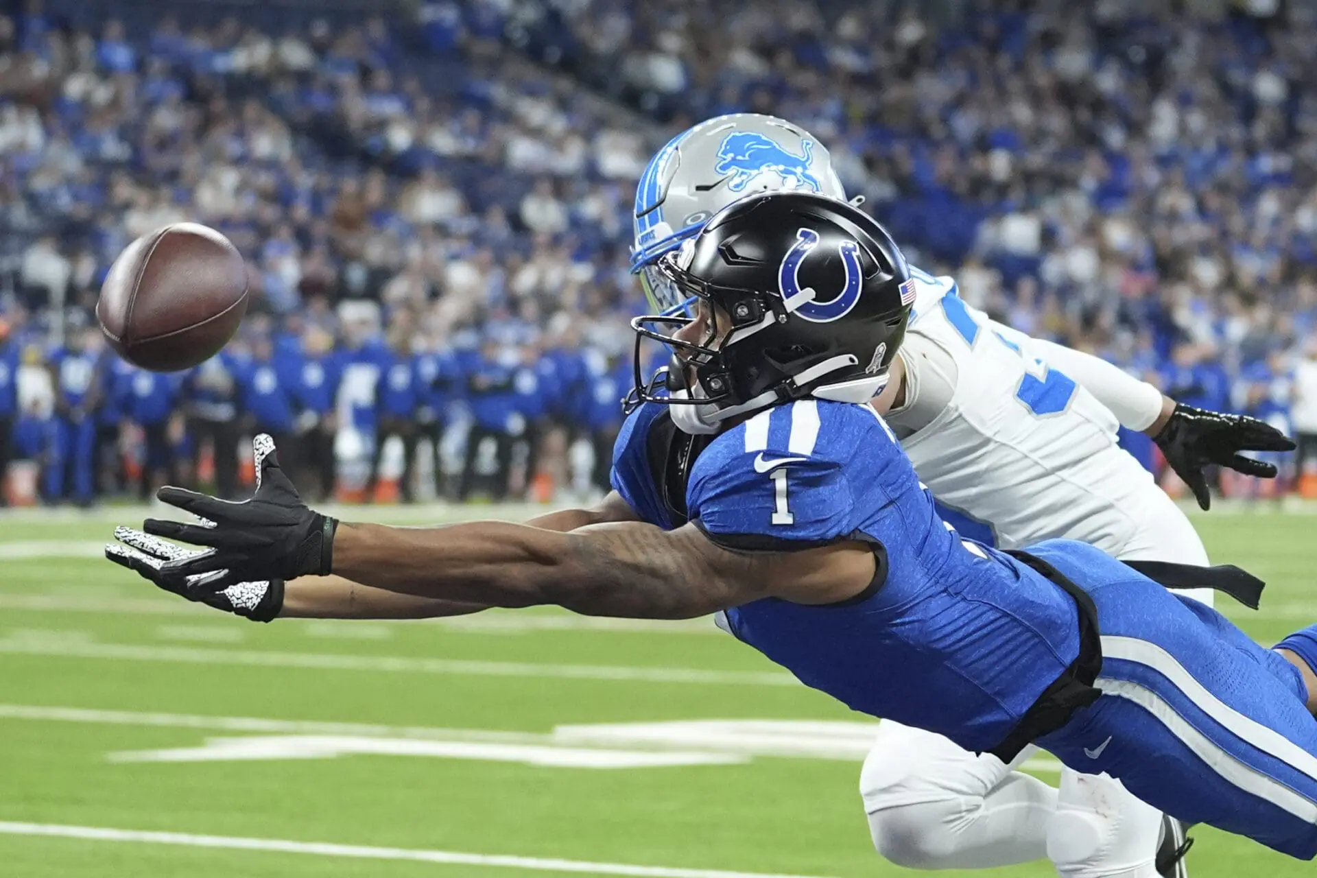 Indianapolis Colts wide receiver Josh Downs (1), defended by Detroit Lions cornerback Khalil Dorsey (30), is unable to catch a pass during the second half of an NFL football game, Sunday, Nov. 24, 2024, in Indianapolis. (AP Photo/Michael Conroy)