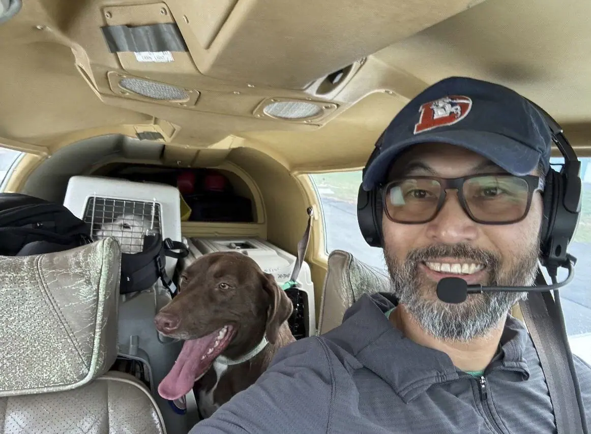 This photo released by The Animal Shelter of Schoharie Valley shows Seuk Kim during a flight to deliver dogs rescued from a euthanasia list to the Animal Shelter of Schoharie County on Nov. 11, 2024. (Animal Shelter of Schoharie Valley via AP)