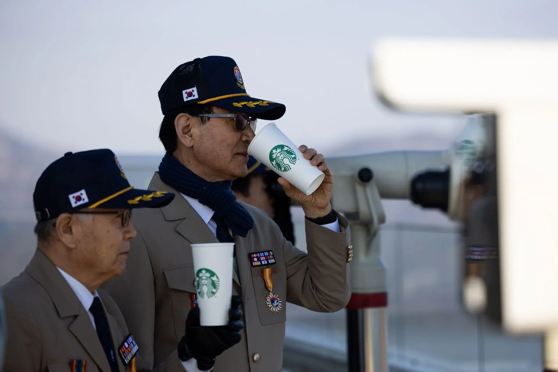 South Korean veterans drink coffee at an observation deck of the Starbucks Coffee in Gimpo. The newest location of the international coffee chain offers a view overlooking North Korea, complete with an observation deck and telescopes. (Provided Photo/SeongJoon Cho/Bloomberg/Getty Images via CNN Newsource)