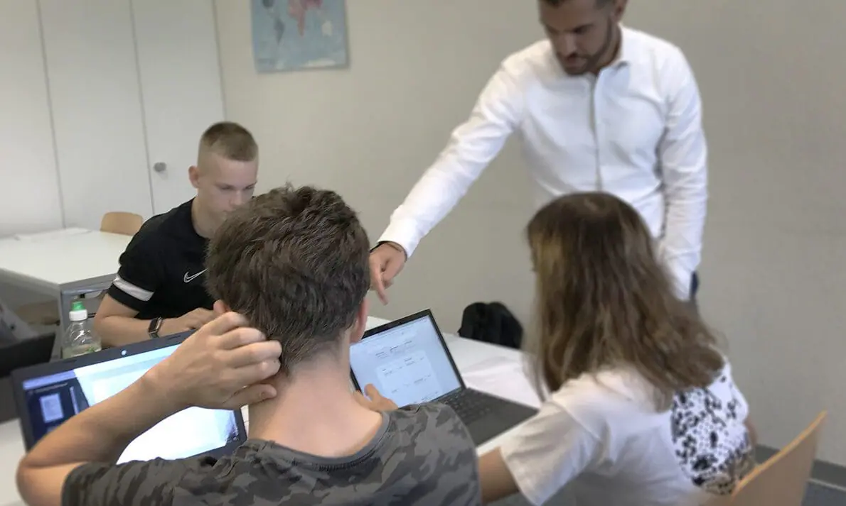 Swiss banking apprentices at the CYP bank training school in Zurich work with trainer Burak Besler on how to handle loan applications. Indiana is basing a new banking academy and apprenticeships on CYP. (Provided Photo/Patrick O’Donnell/The 74)