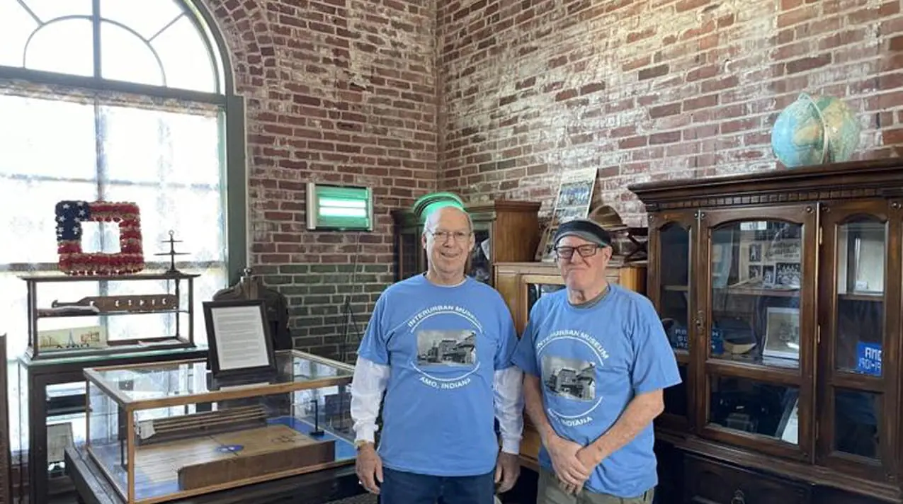 Amo residents Dave Phillips and Darrell Mynatt, both graduates of Amo High School and members of the museum committee, pose with a miniature replica of the basketball court. (Provided Photo/The Republican)