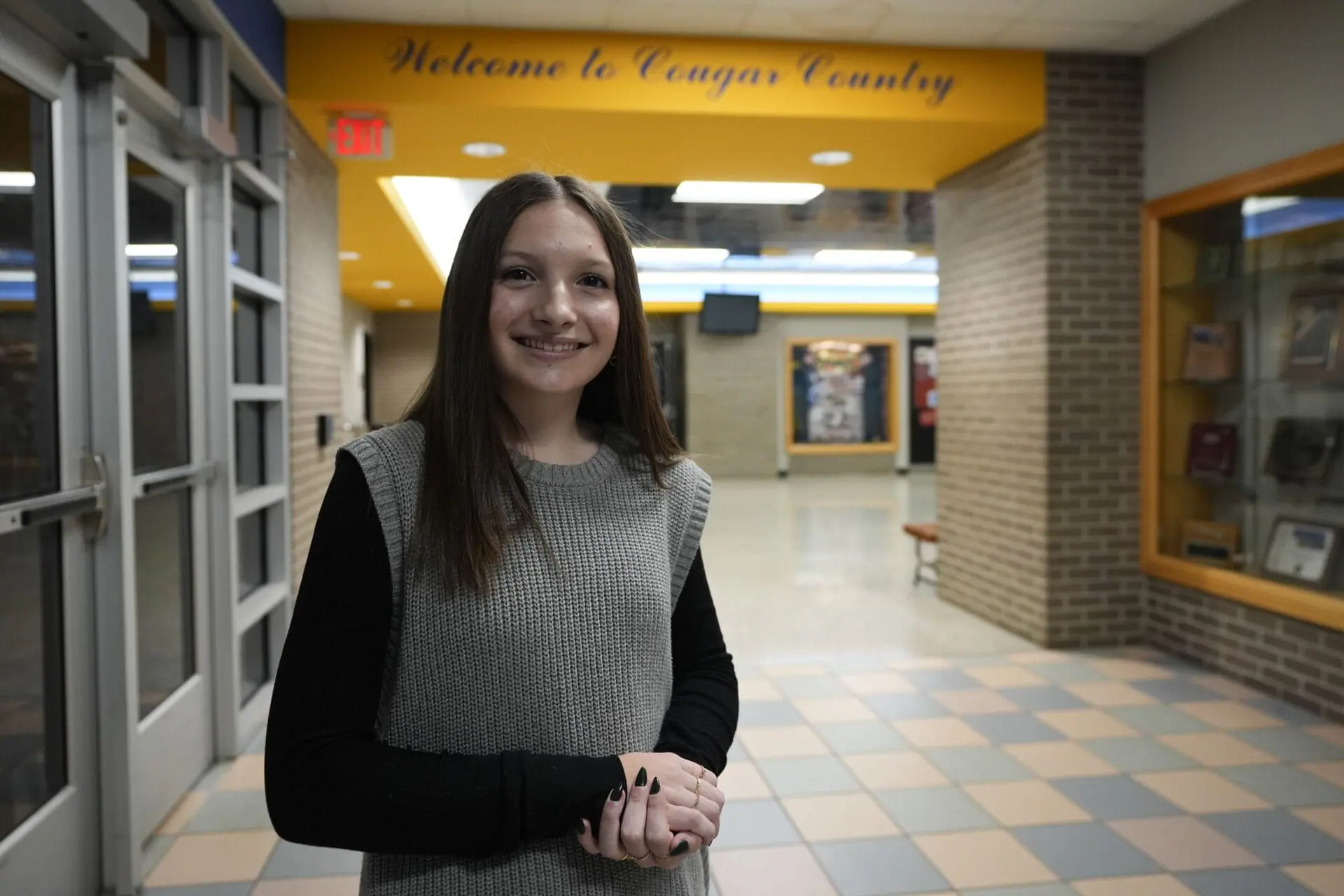 Makenzie Gilkison stands in the main lobby at Greenfield Central High School, Tuesday, Dec. 17, 2024, in Greenfield, Ind. (AP Photo/Darron Cummings)