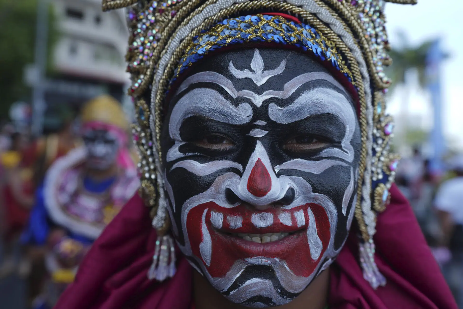 A Cambodian dancer with painted face waits before performing during the 