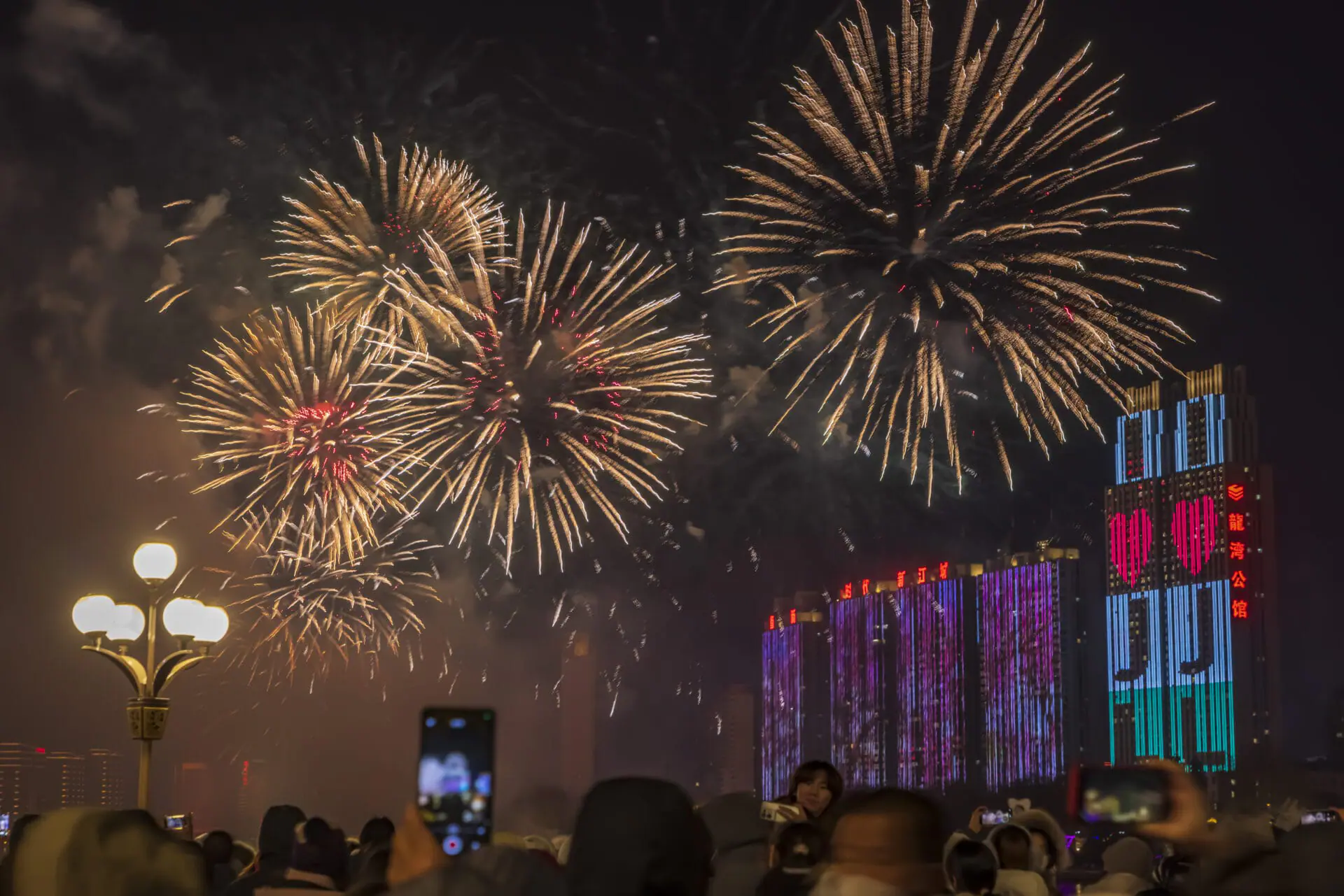 JILIN, CHINA - DECEMBER 31: Fireworks light up the sky over the Songhua River during a firework show to welcome New Year 2025 on New Year's Eve on December 31, 2024 in Jilin City, Jilin Province of China. (Photo by VCG/VCG via Getty Images)