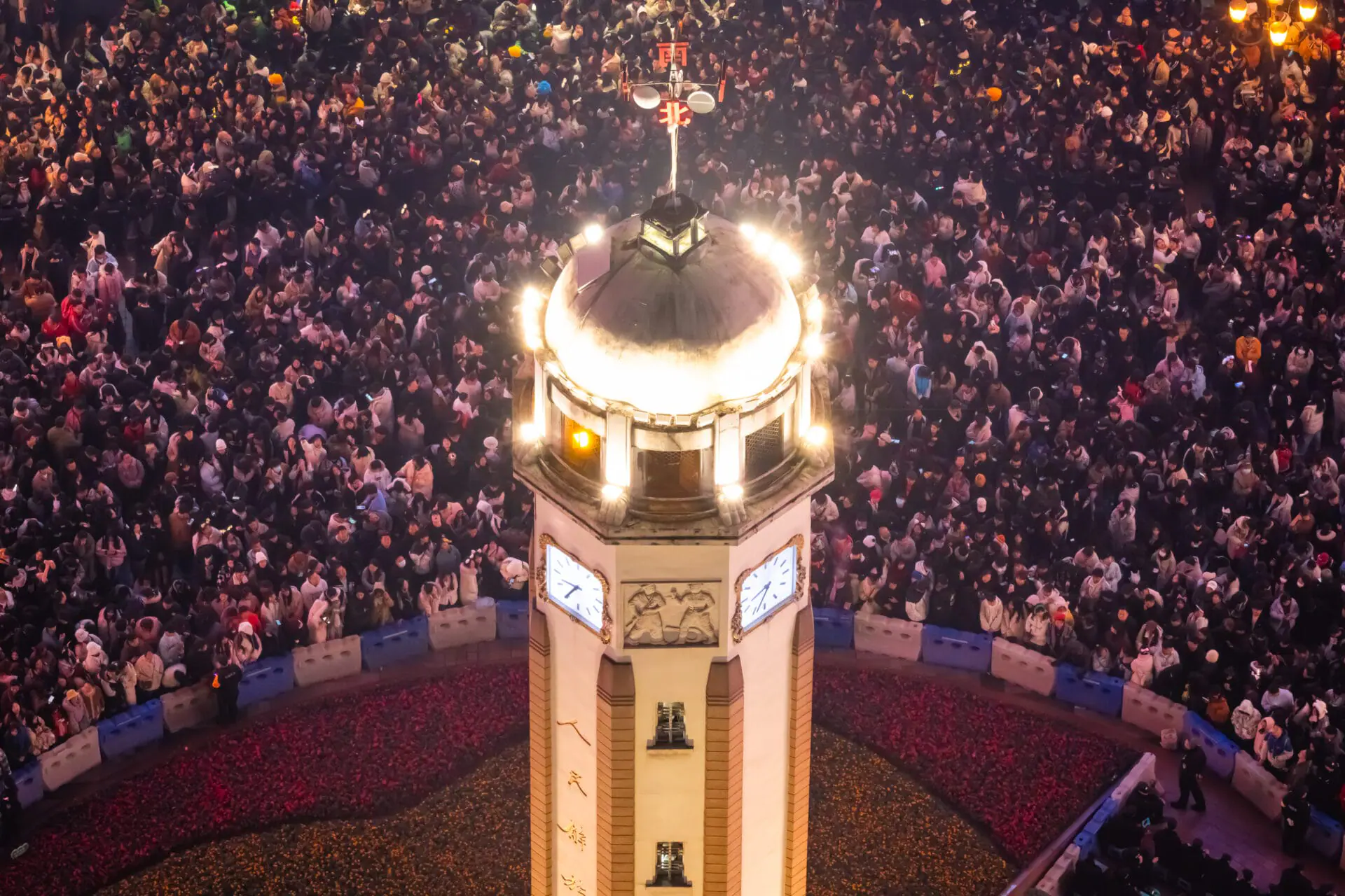 A close-up aerial view of the illuminated Jiefangbei Monument surrounded by a massive crowd of revellers during New Year’s Eve celebrations on December 31, 2024, in Chongqing, China. Revellers turned out in large numbers to celebrate the new year in Chongqing. (Photo by Cheng Xin/Getty Images)